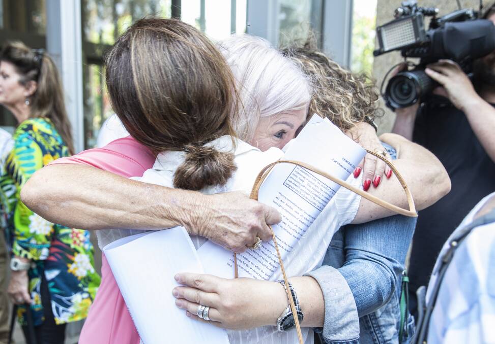 Victory: Women hug outside the Federal Court in Sydney after Justice Anna Katzmann found they had won their case against pelvic mesh device manufacturer Johnson & Johnson. Picture: Louie Douvis.