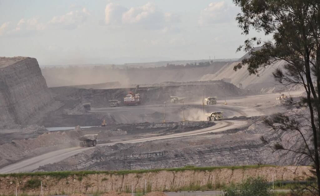 Dusty: Coal trucks work at a Hunter open cut coal mine. 
