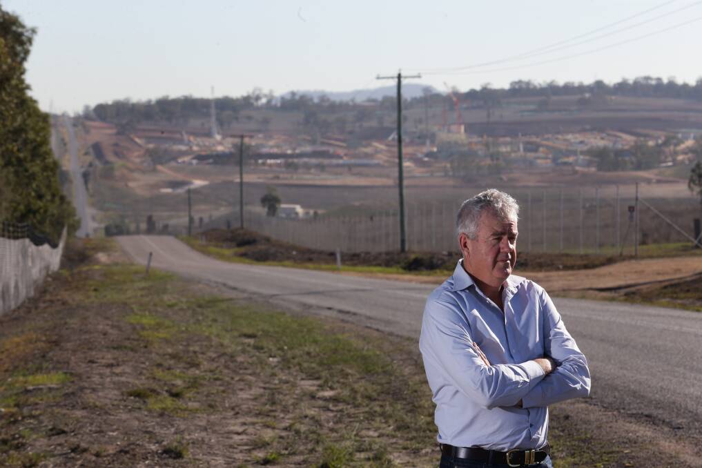 Fiery: Muswellbrook shire councillor Graeme McNeill with Muswellbrook in the background. Mr McNeill led councillors who challenged government department representatives during what he called a "fiery meeting" early this year. Picture: Jonathan Carroll.