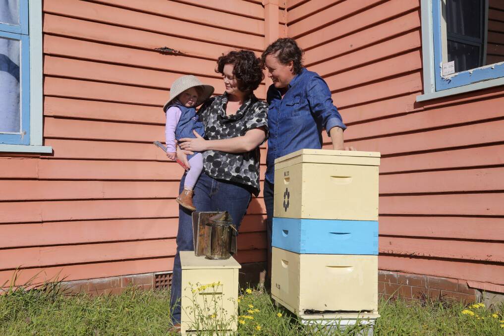 BEE-LOVED: Anna Scobie and Kelly Lees, right, with their daughter Nancy, 17 months, pictured at the Mayfield apiary. Pictures: Ellie-Marie Watts