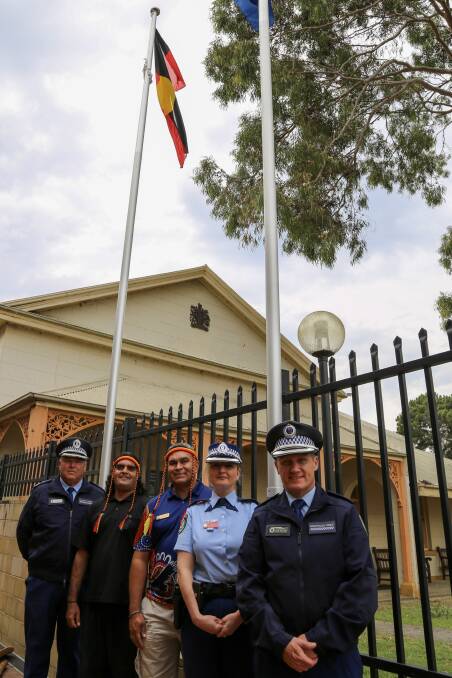 The Aboriginal flag was raised and a smoking ceremony held at Raymond Terrace Police Station on Tuesday. Pictures: Ellie-Marie Watts
