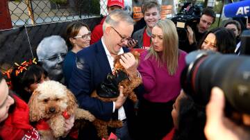 Anthony Albanese, with partner Jodie Haydon, started election day in the Melbourne seat of Higgins. Picture: AAP 