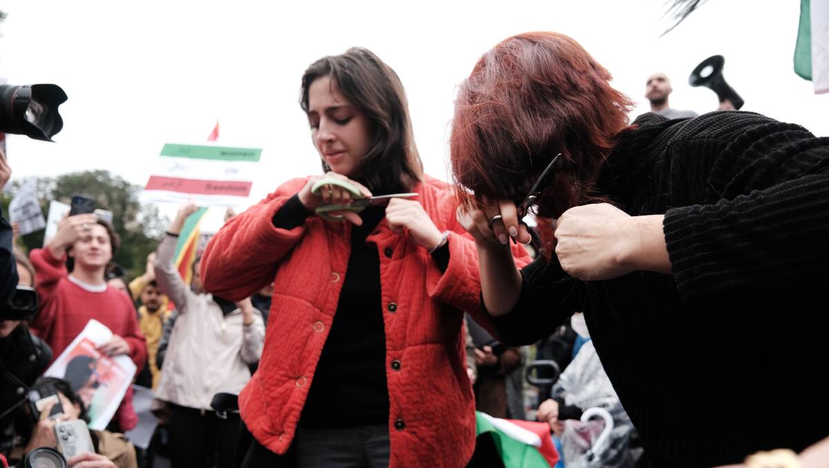 Protesters cut their hair in solidarity to show their opposition to the Iranian regime following the death of Mahsa Amini. Picture Getty Images
