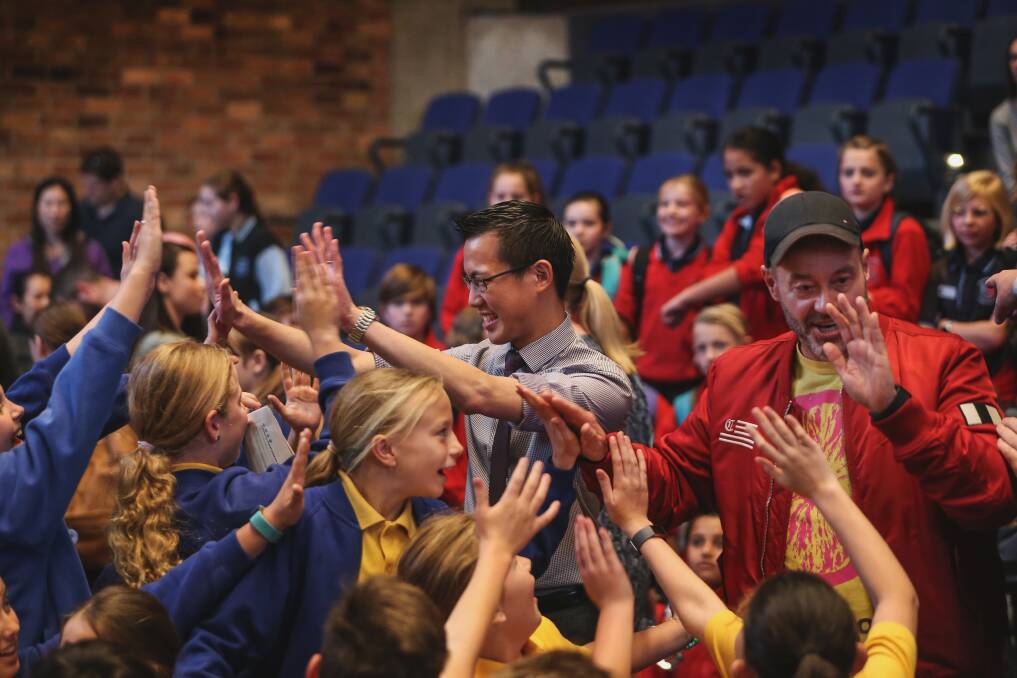 GOT THE NUMBERS: Eddie Woo and Adam Spencer high-five students from St Joseph's Primary School. Picture: Marina Neil 