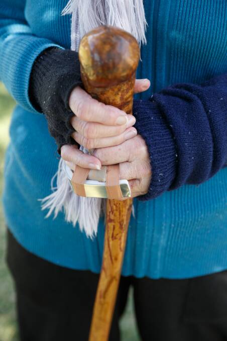 DEFEND: Pamela Williams holds the walking stick she used to try and fend off the dogs before running for help. Picture: Max Mason-Hubers