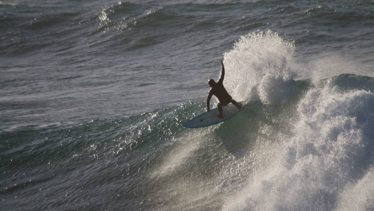 SHAPES: Rod Owen surfs off Merewether Beach on Tuesday. Picture: Dave Anderson 
