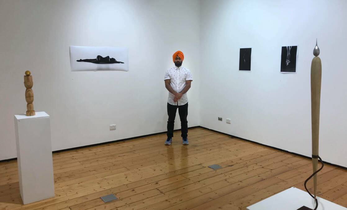 FIRST EXHIBITION: Harsimranjeet Singh Brar at the first solo exhibition of his sculpture and photography at the University of Newcastle's art gallery in October. Picture: Supplied