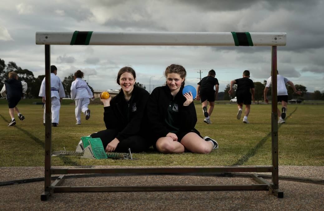 DAY OF NORMALITY: Abbey McDonald and Alyssa McDonald check out the equipment at Vi Barnett Field. Surrounding children cannot be identified for child protection reasons. Picture: Marina Neil 
