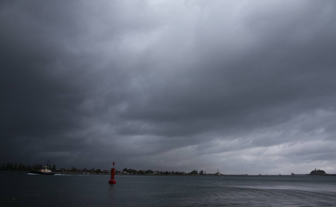SEA CHANGE: The sky darkening over Newcastle harbour on Wednesday afternoon. 