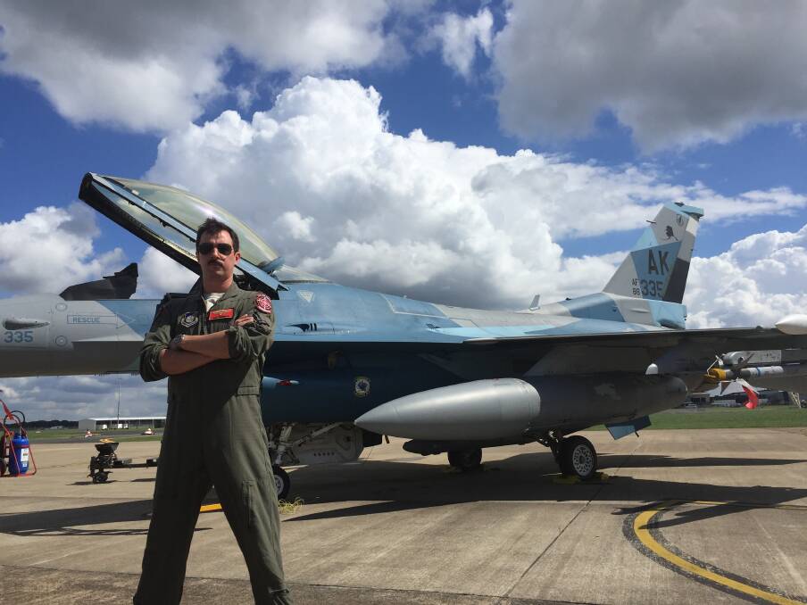 ON A MISSION: Captain Chris Prochnow of the US Air Force's 18th Aggressor Squadron in front of an American F-16 Fighting Falcon at Williamtown. Picture: Phoebe Moloney 