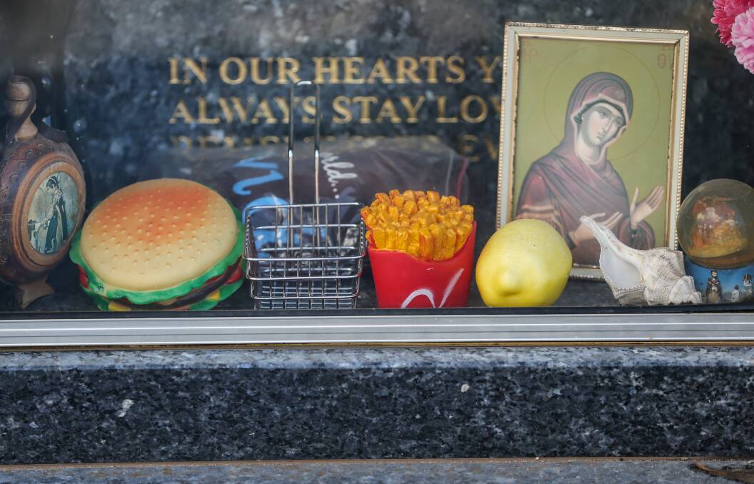 PERSONALITY: Items left at a headstone in Sandgate Cemetery. Picture: Marina Neil