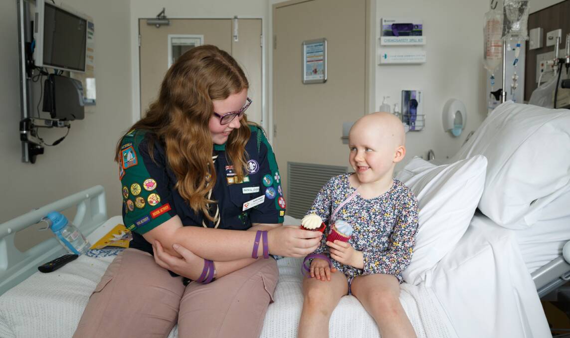 ICING ON TOP: Cancer survivor and NSW Scout of the Year Jacinta Gomez in John Hunter's Paediatric Oncology ward with patient Ena Burgess, 4. Jacinta is fundraising for the ward through Cupcakes for Cancer. Picture: Max Mason-Hubers 