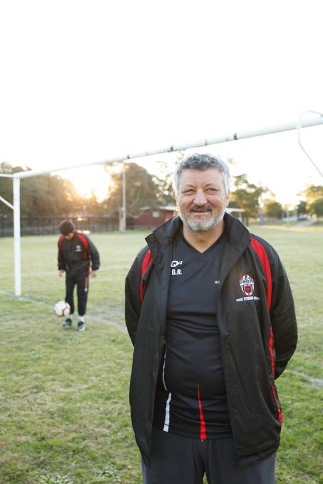 COACH: Abdelfattah Ben Romdhane, coach of Simba FC, with his son Sohel at Newcastle TAFE oval in Tighes Hill. Picture: Max Mason-Hubers