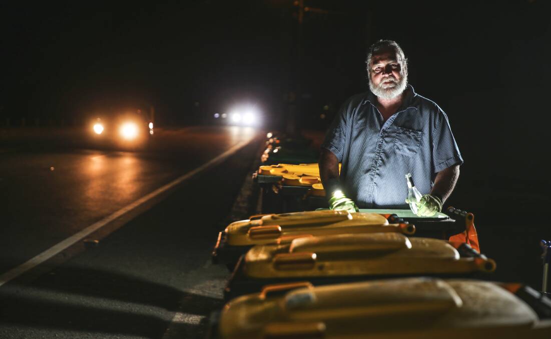 NIGHTTIME ECONOMY: Frank Davis spends hours of his day going through bins around Newcastle, collecting bottles and cans. Picture: Marina Neil