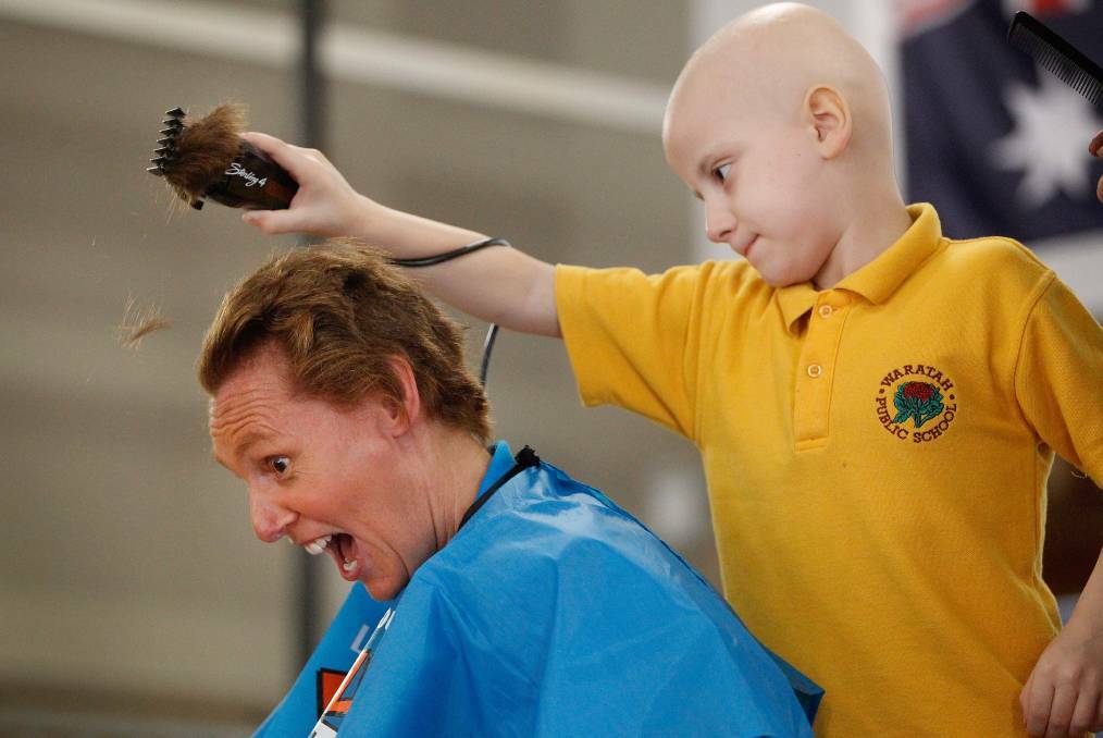 WHAT HAVE I DONE: Waratah Public School teacher Sue McGregor receiving a hair cut from student Kane Ransom in 2018. Picture: Marina Neil.