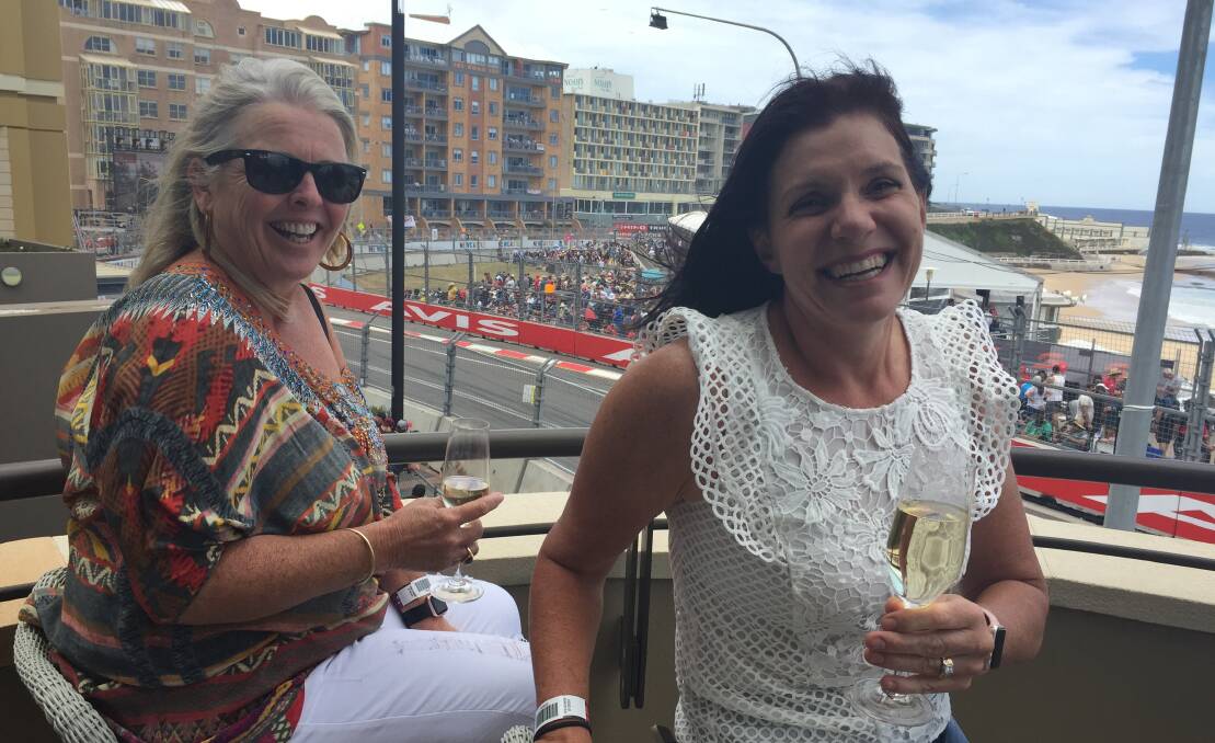 LUCKED OUT: Jane Dukes and Pauline Liddle enjoying the races from their friends' balcony. Picture: PHOEBE MOLONEY