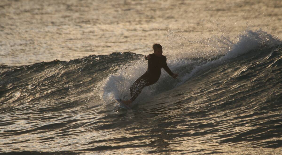 BREAK: Gus Nicholson fits in an early morning surf on Thursday. Picture: Dave Anderson