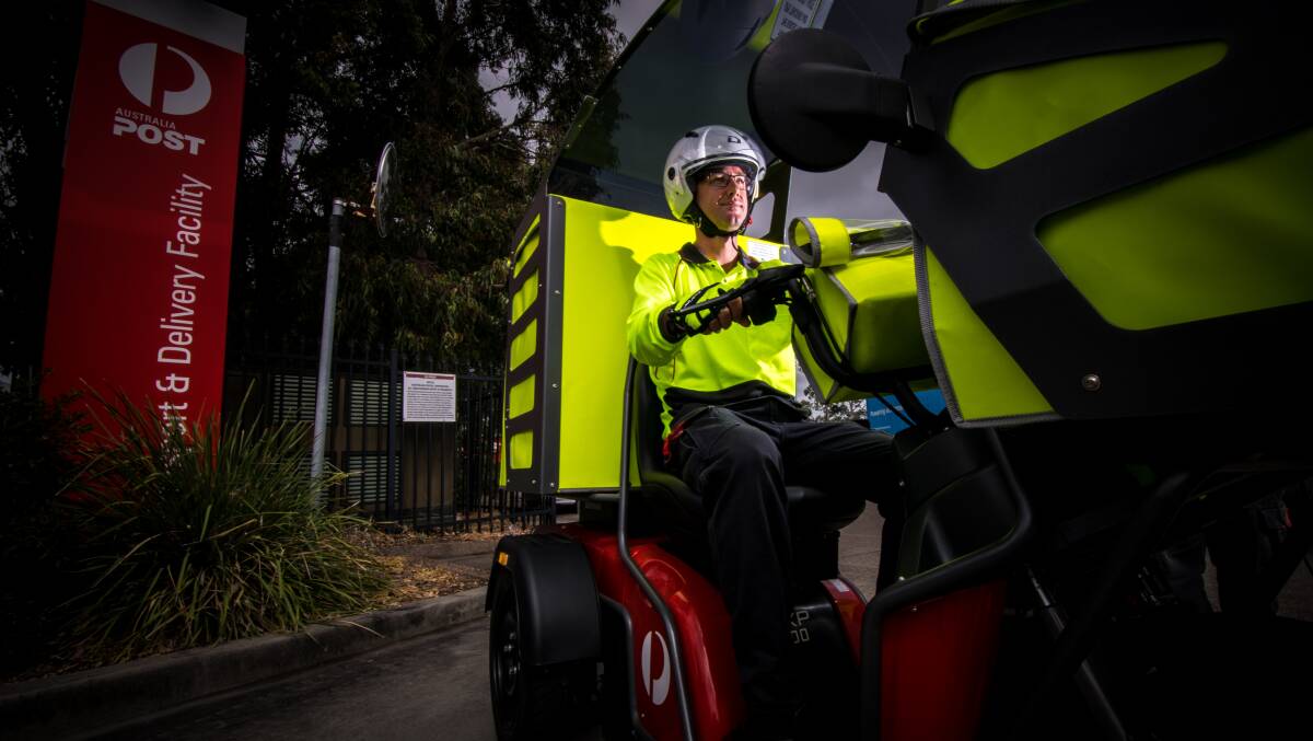 WHEELS: Long-time postie Steven Richards with one of the electric vehicles in October, 2017, when the trial for the bikes in Newcastle began. 