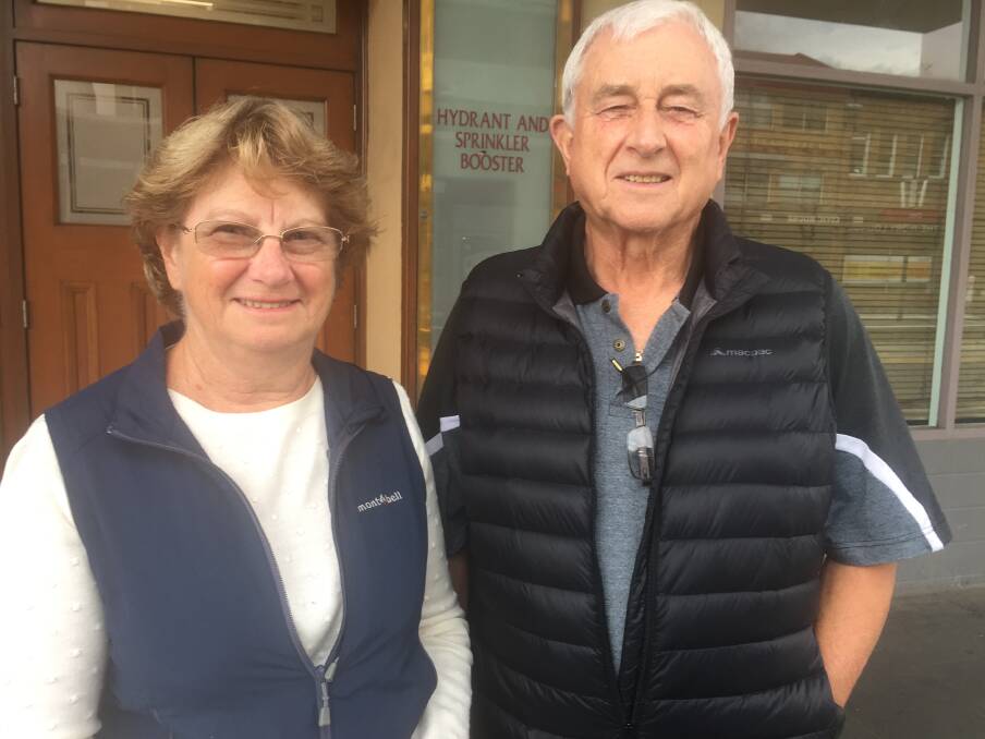PLANNING: Kim McHugh and Greg McCosker of Cooks Hill were looking at the bottom line of parties' policies. 