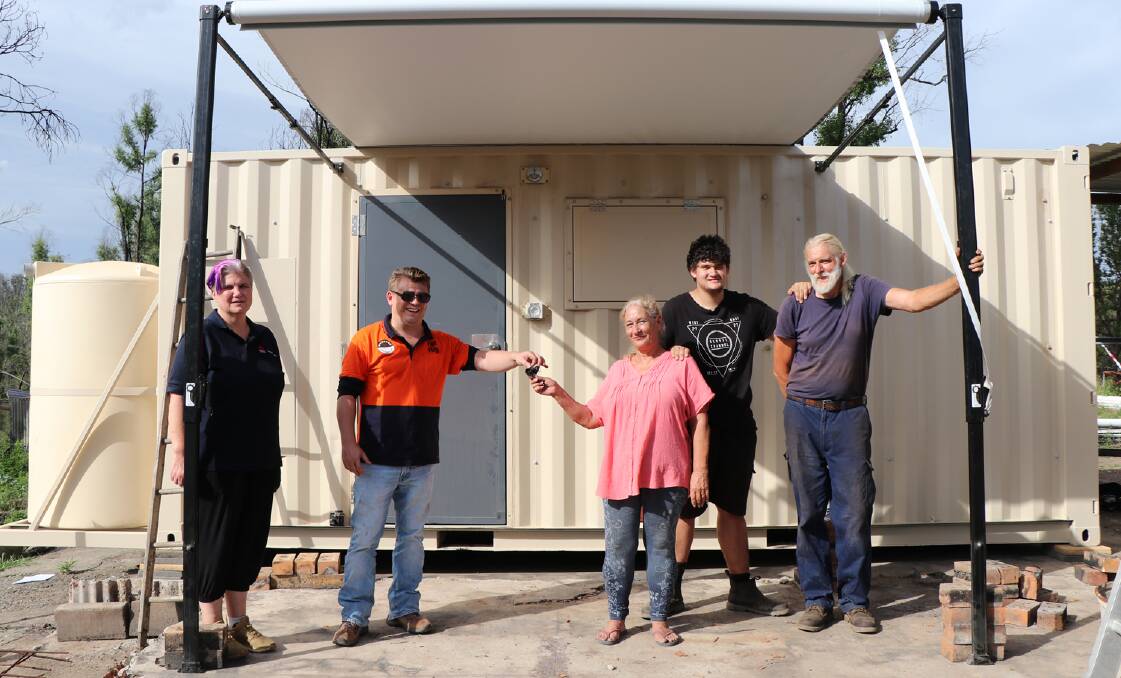 Home delivered: The Richardson family of Kempsey are presented with the keys to their
accommodation pod.