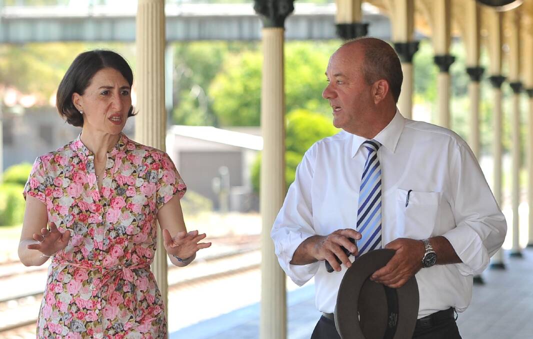 Then NSW Transport Minister Gladys Berejiklian and then Wagga MP Daryl Maguire at Wagga's railway station in 2015. ICAC on Thursday heard intercepted phone calls between the pair in which Ms Berejiklian agreed to "throw money at Wagga" during the 2018 byelection.
