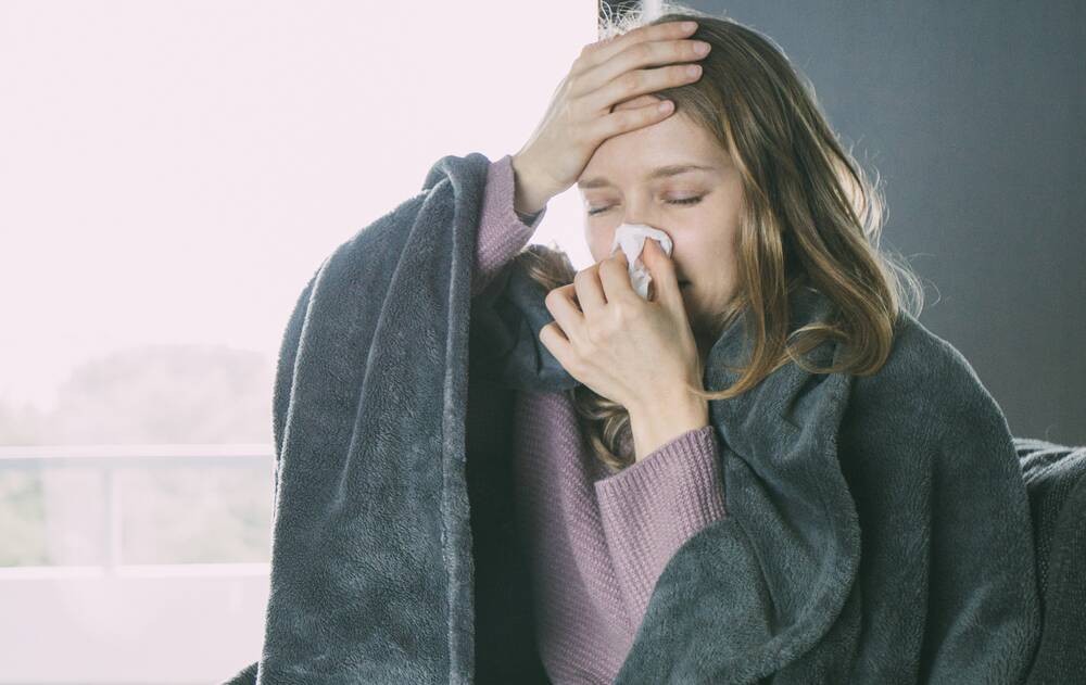 Flu symptoms vary depending on age and severity, but include fever, chills, muscle aches, cough, congestion, runny nose, headaches and fatigue. Photo: Shutterstock.