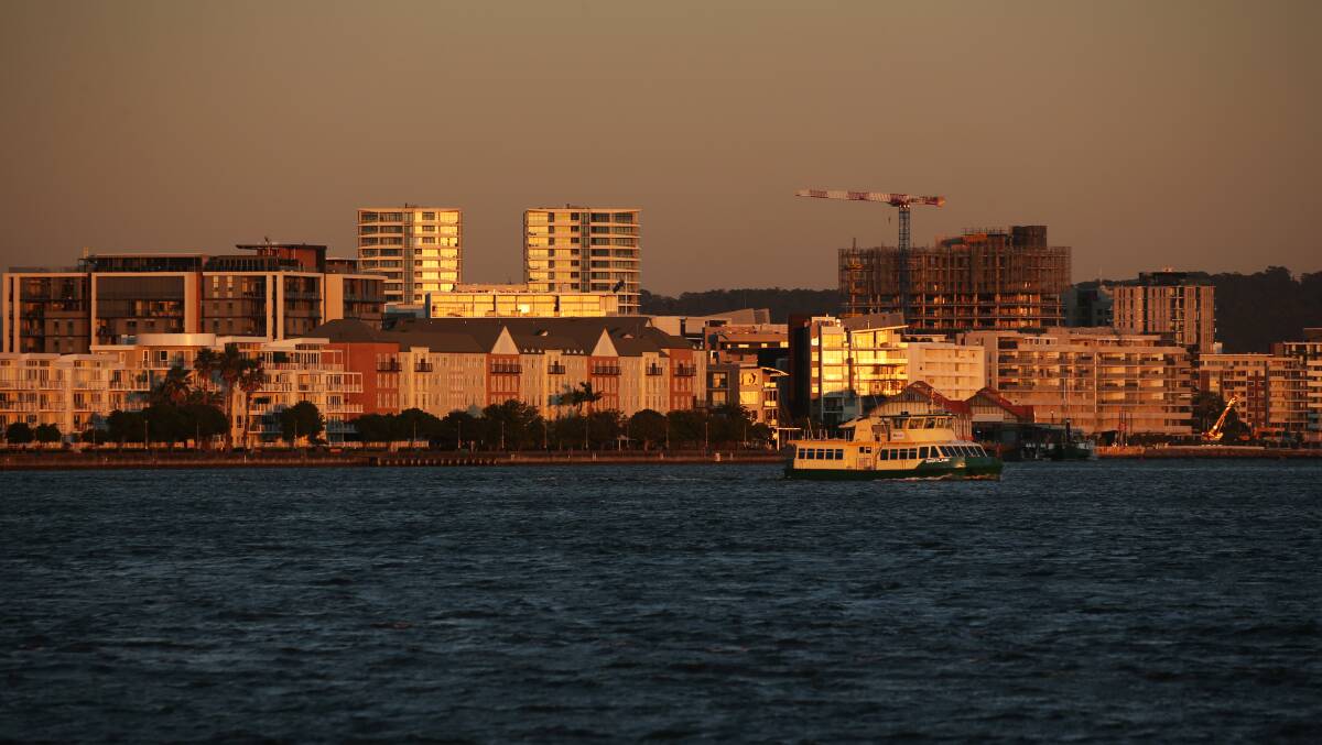 The residential and commercial buildings along the harbour at Honeysuckle at dawn. Picture: Simone De Peak 
