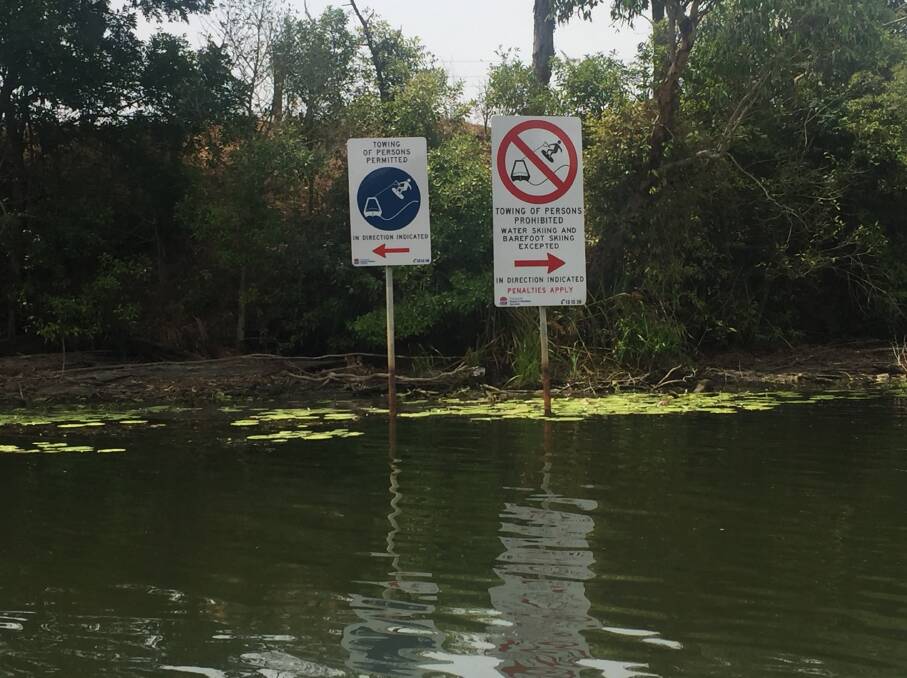Signs on the Williams River. Picture: Scott Bevan
