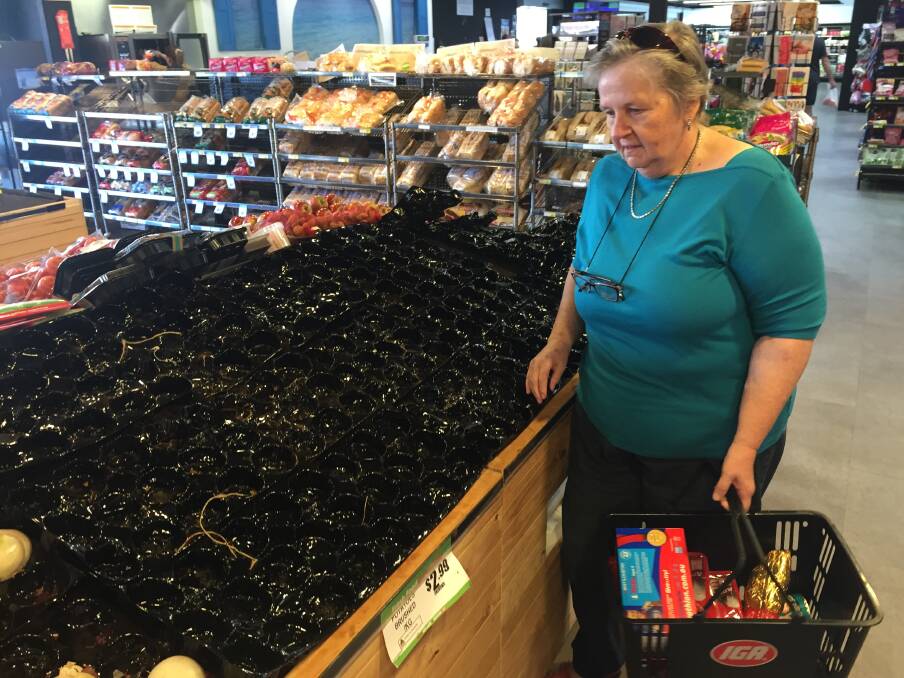 SEARCHING: Shopper Sue Gumbleton looks at the largely stripped potato section. 