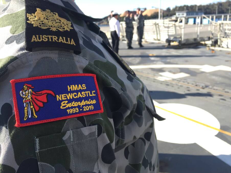 BADGE OF HONOUR: Officers and sailors welcome dignitaries aboard HMAS Newcastle. Picture: Scott Bevan