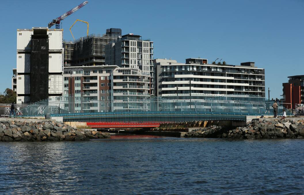 Cottage Creek entering the harbour, as buildings rise in the background. Picture: Simone De Peak 