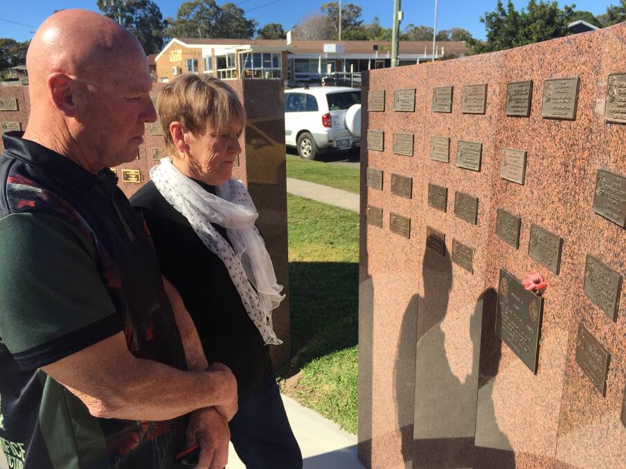 FAMILY GRIEF: Shane Hines and his mother, Norma Hines, stand before the commemorative plaque to father and husband, Lieutenant Peter Hines, at the memorial in Wangi Wangi. 