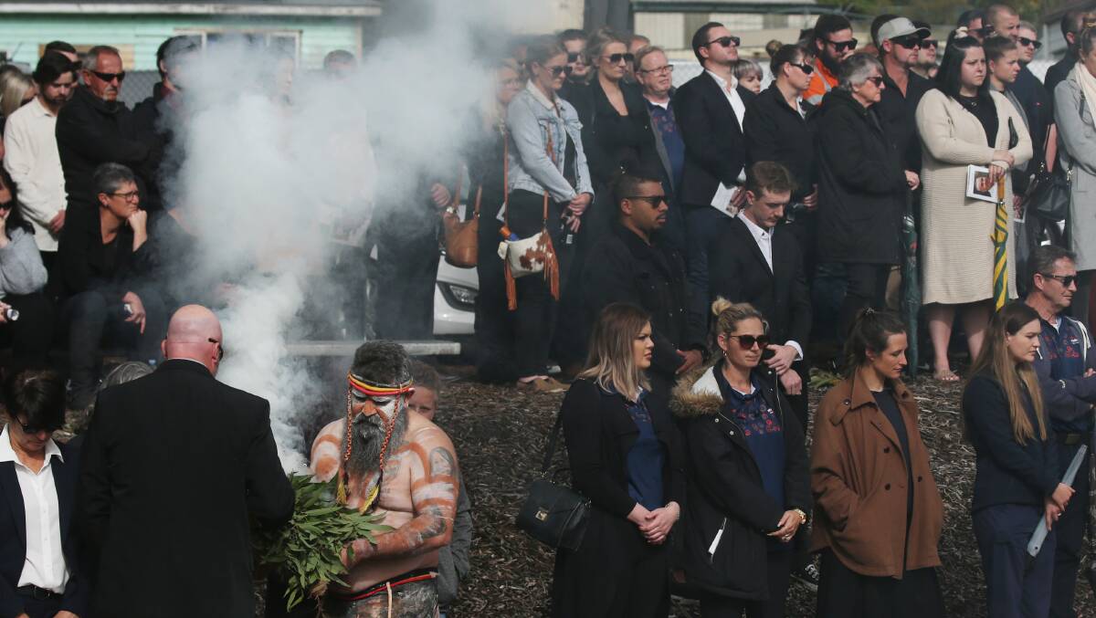 Worimi man Justin Ridgeway conducts a smoking ceremony at the funeral service. Picture: Simone De Peak