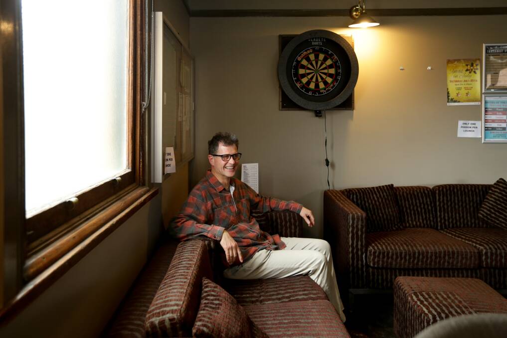 Author John Hughes sits in the corner of the bar where his grandfather used to play the accordion. Picture: Jonathan Carroll