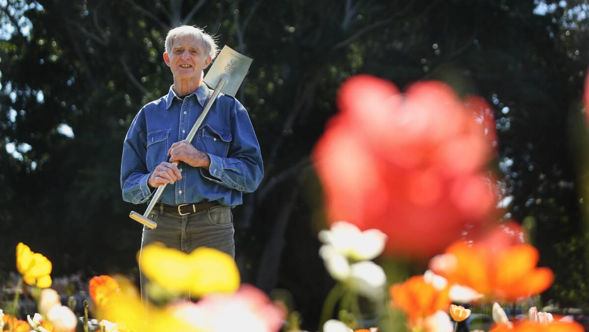 Gardener of the Year John Le Messurier, with his trophy spade, among the annuals blooming in the garden beds at Civic Park. Picture: Marina Neil 