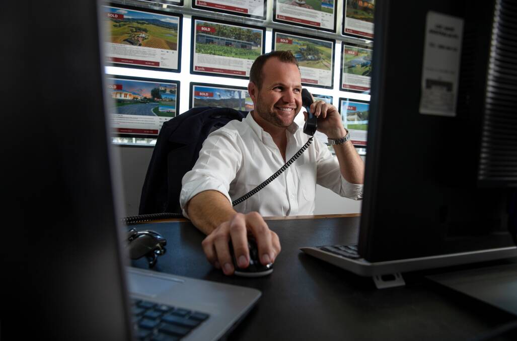 BUSY: Jurds real estate agent Cain Beckett in his Cessnock office. Picture: Marina Neil