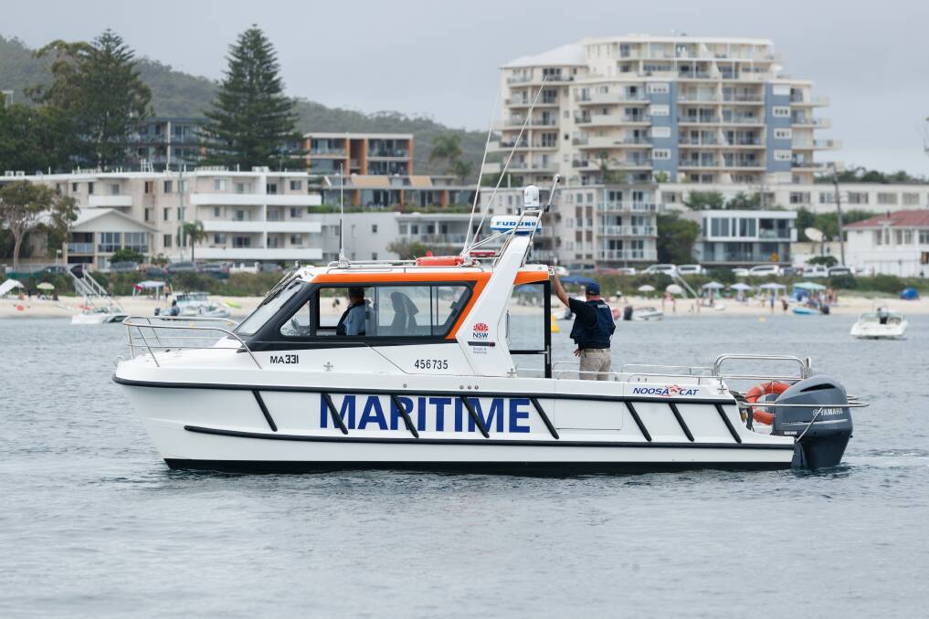 PATROL: The Maritime NSW vessel cruises along the Port Stephens shoreline near Shoal Bay.