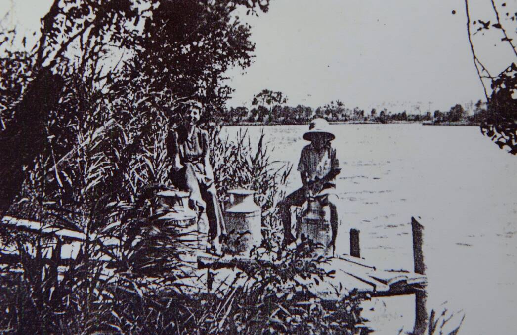 John O'Keefe, as a boy and photographed in 1942 (in the hat), sitting by the Williams River. Picture: Courtesy, O'Keefe Collection