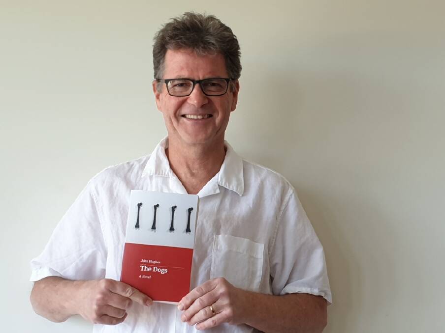 NEW BOOK: Author John Hughes holding a copy of his novel, "The Dogs". Picture: Supplied