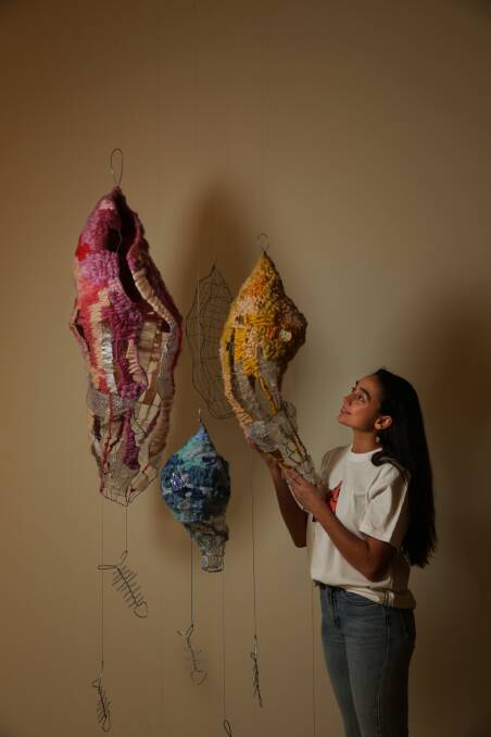 NEW IDEAS: Artist Jasmine Miikika Craciun with her work, "Empty Water Vessels", in the "we" exhibition.