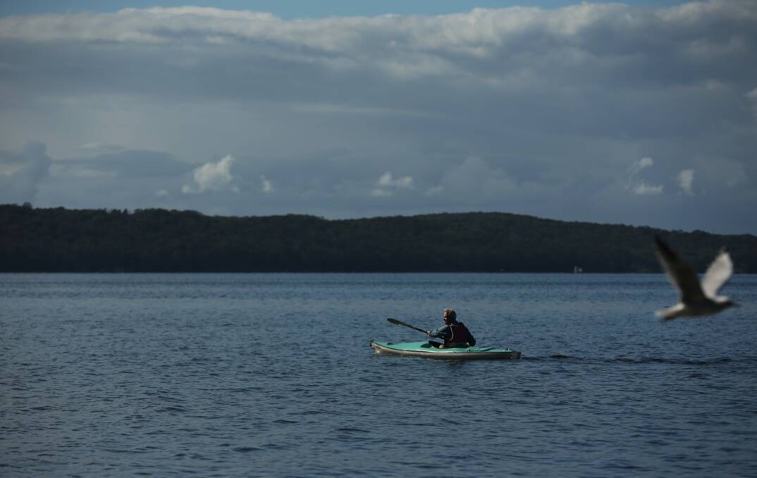 Scott Bevan paddling on Lake Macquarie. Picture: Simone De Peak