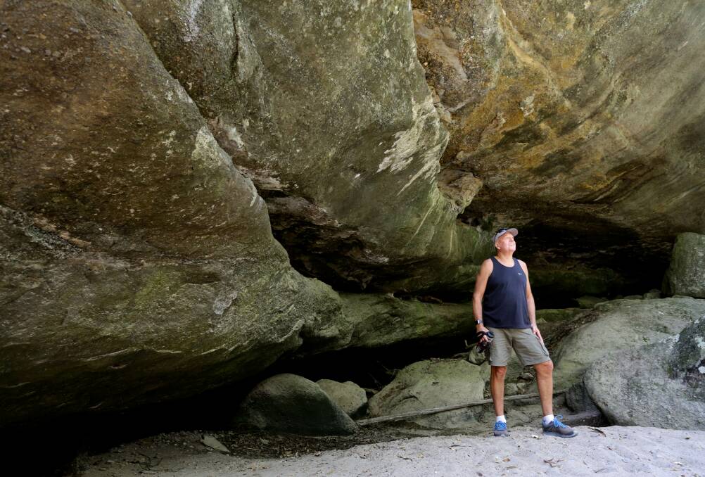 Martin Parker inspects Jewboy Cave, reputedly the hiding place of a colonial bushrangers' gang. Picture: Jonathan Carroll 