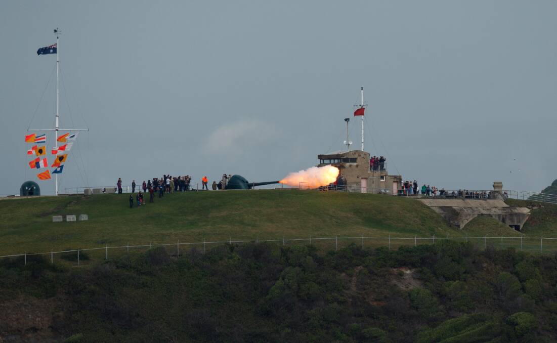 A seven-gun salute booms out from Fort Scratchley to acknowledge the final departure of HMAS Newcastle from the port of its namesake city. Picture: Max Mason-Hubers