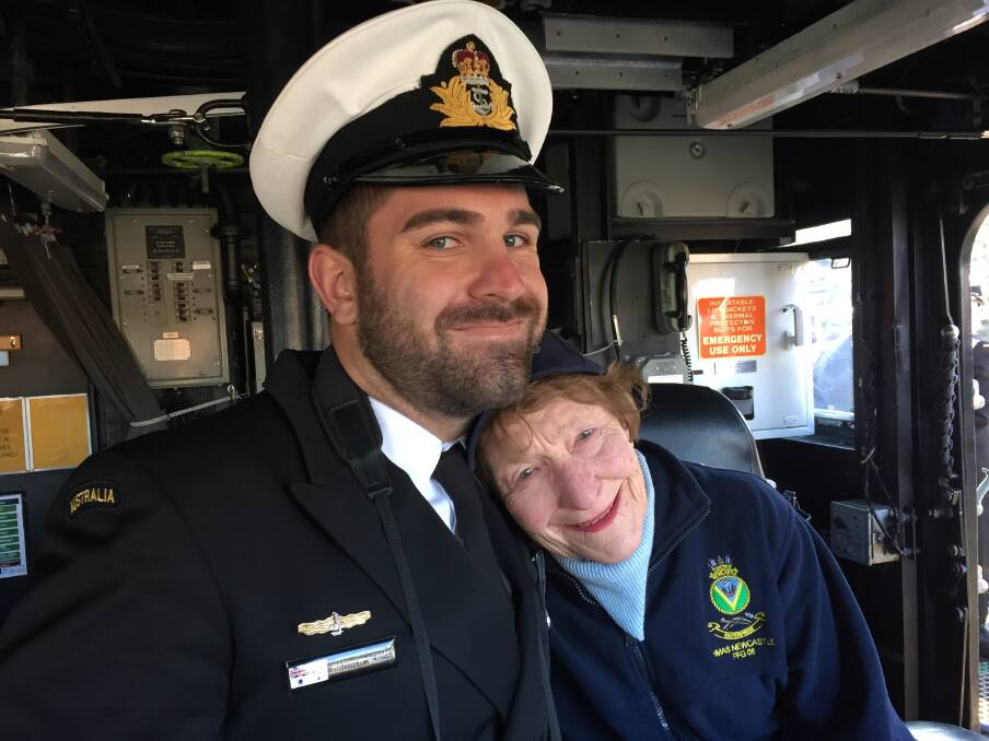 Sub Lieutenant Matthew Newman with former Lady Mayoress Margaret McNaughton on board HMAS Newcastle. Picture: Scott Bevan
