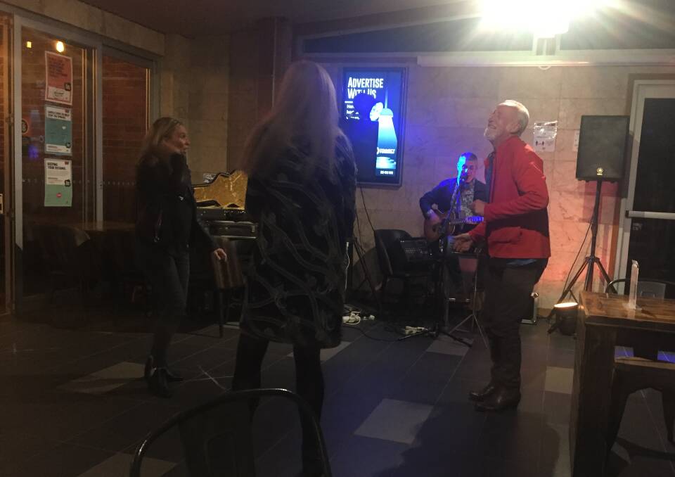 FREEDOM: A few members of the audience dance (while observing social distancing) as Nick Raschke plays at the first live performance since mid-March at the Wickham Park Hotel. Pictures: Scott Bevan