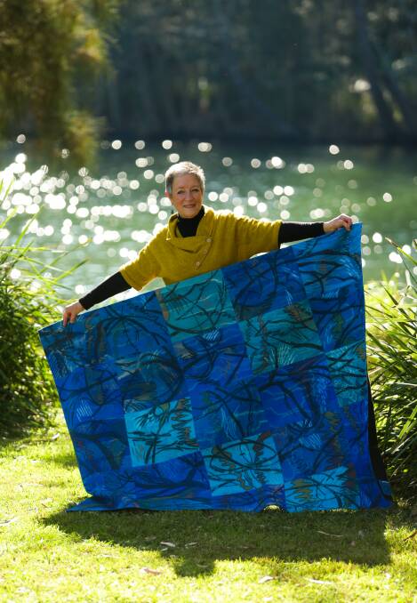 Textile artist Judy Hooworth with her quilt, "Creek Drawing #14", by Dora Creek. Picture: Jonathan Carroll 
