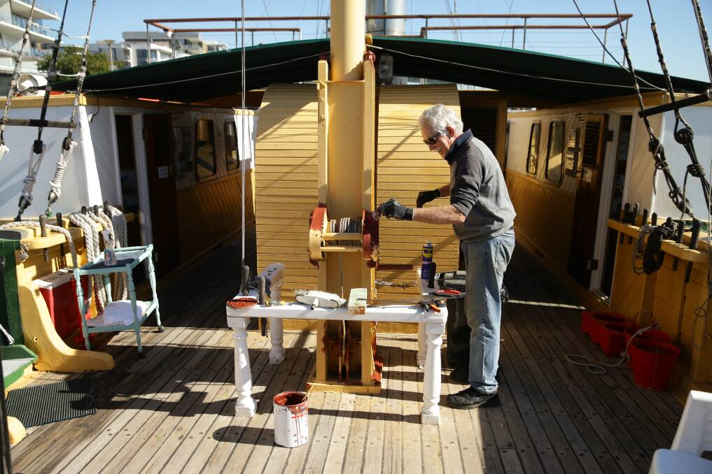 NEW COAT: Volunteer Peter Robinson works on the mast.