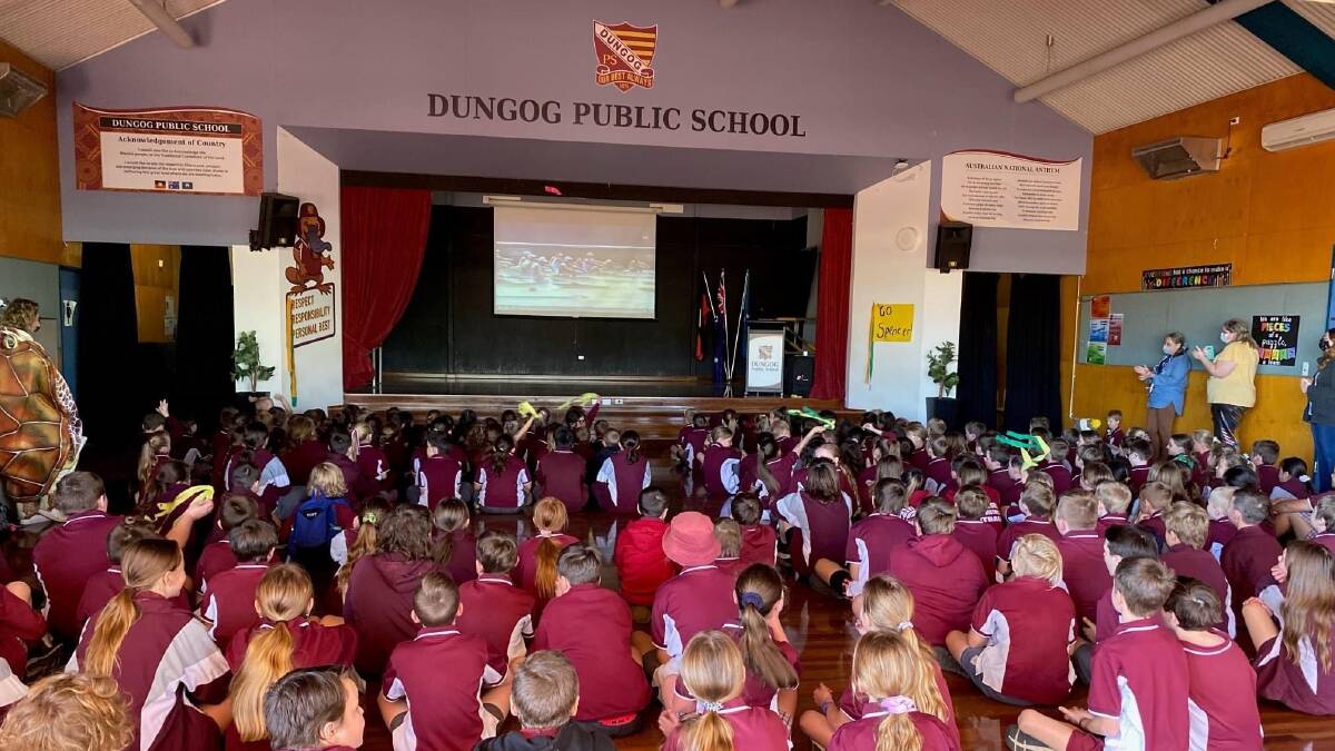 Staff and students of Dungog Public School watch their former school captain in the rowing final. Picture: Courtesy, Karina Burke, Dungog Public School