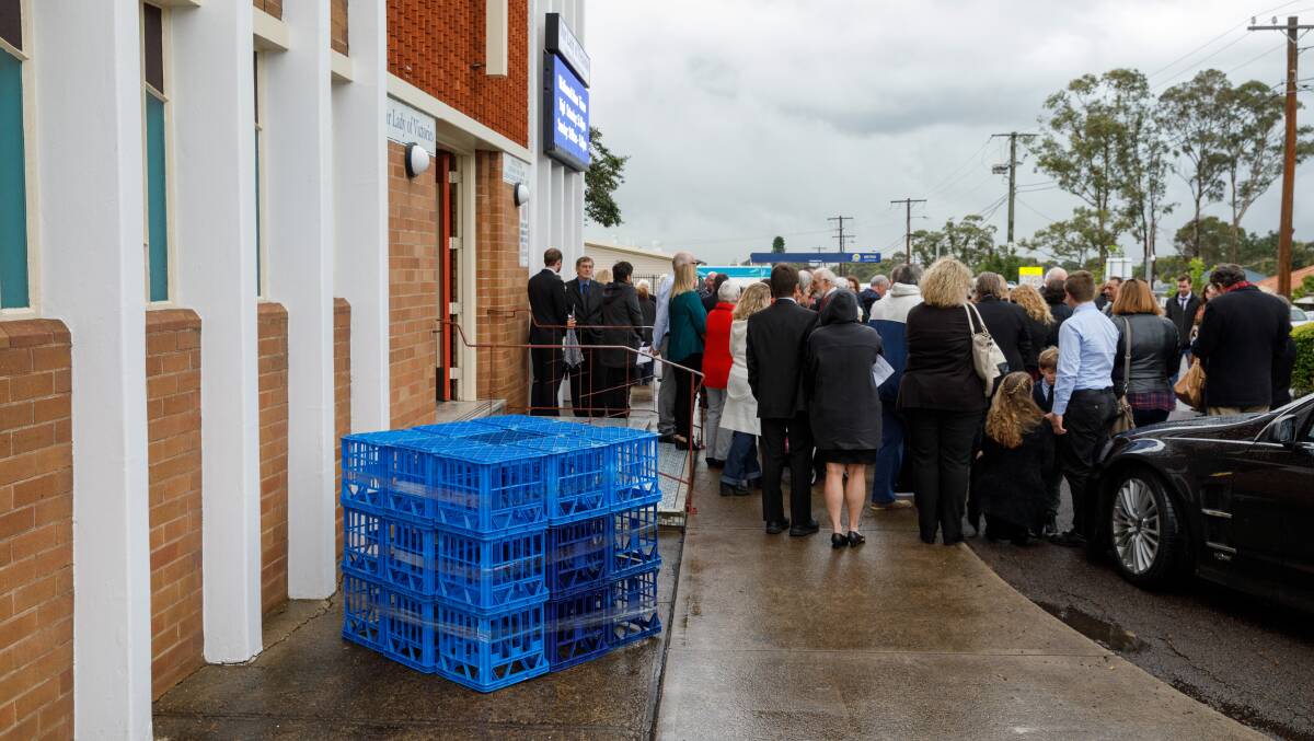TRIBUTE: Twenty-seven blue milk crates, which was the favourite seat of Bernie Sessions, are arranged outside the church. Picture: Max Mason-Hubers