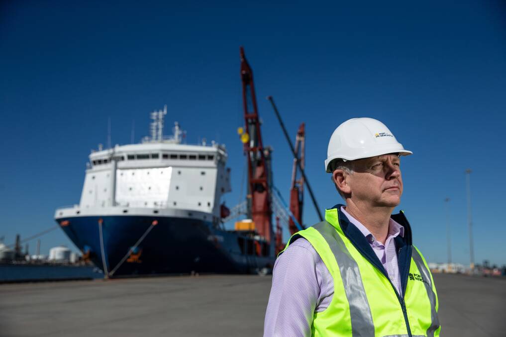 Port of Newcastle CEO Craig Carmody, with the two mobile harbour cranes, delivered by ship in August, in the background. Picture: Marina Neil